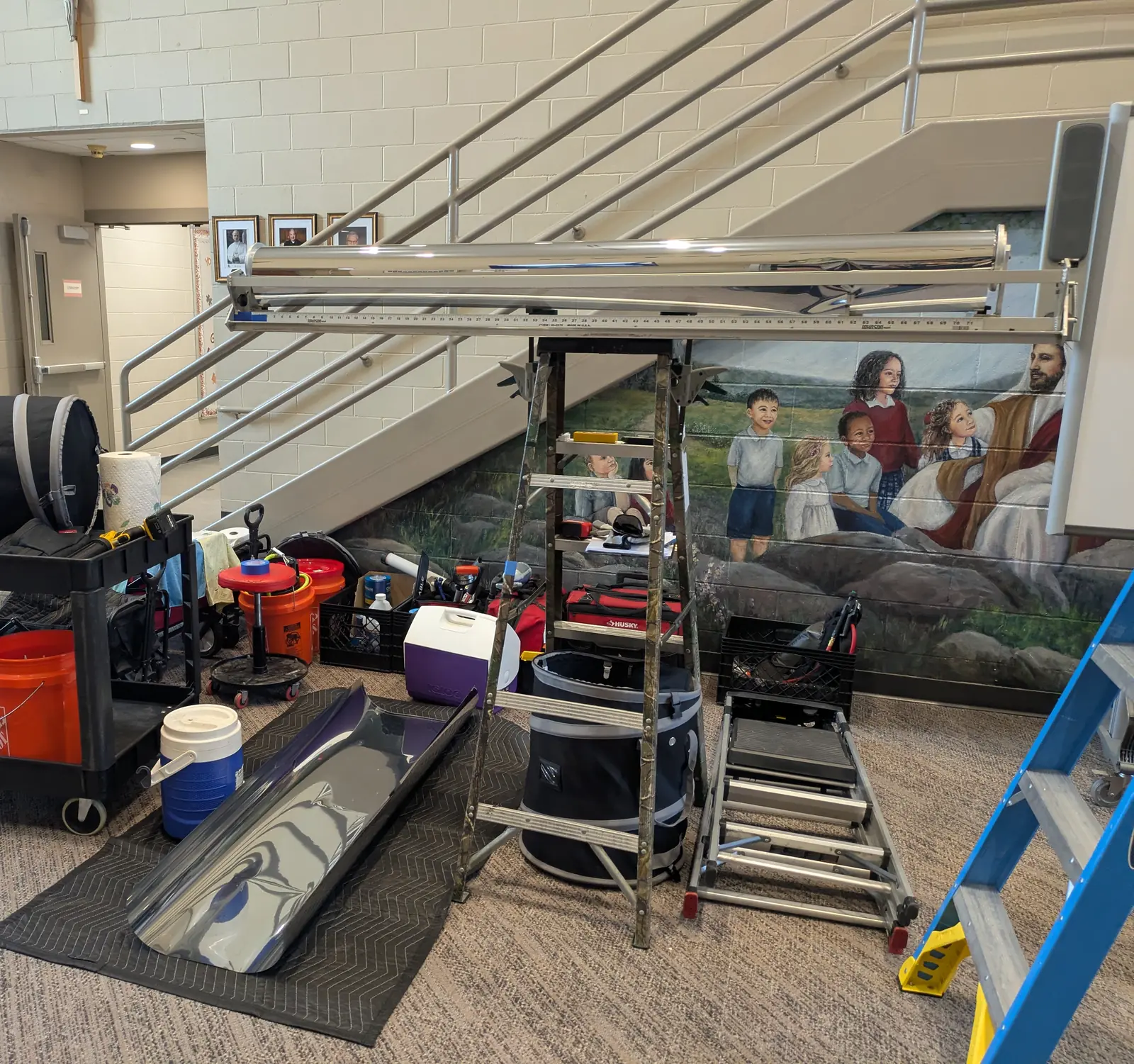 Window film tools and security film staged under a stairwell in a church facility