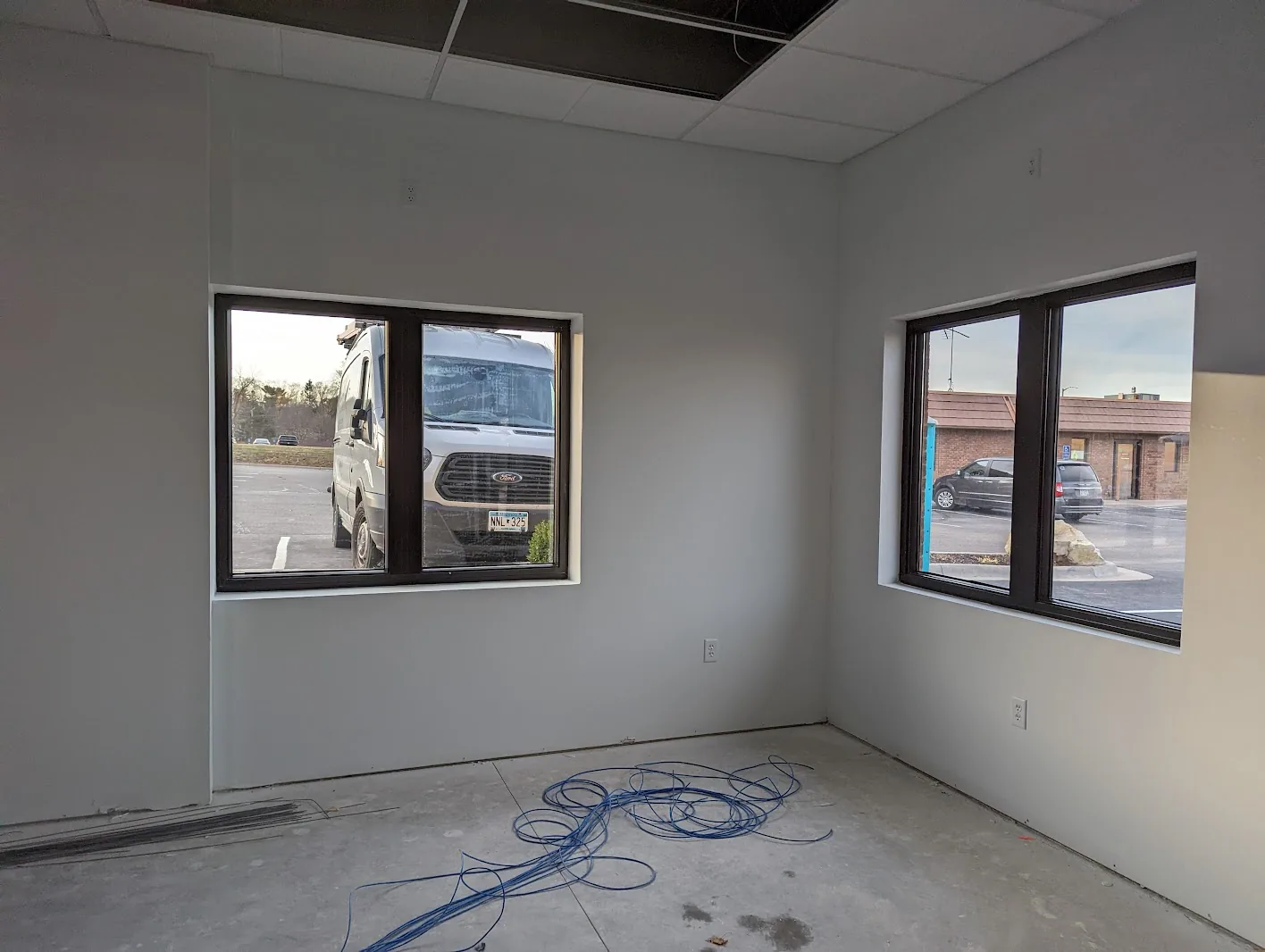 Classroom-style room with windows prepped for security film installation