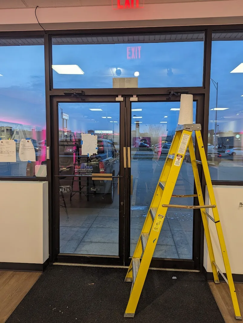 Retail store glass entry doors during security film installation