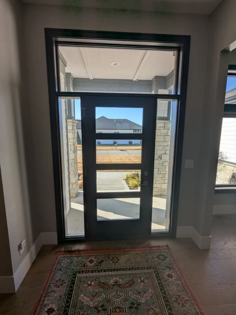 Front entry door with glass panels, sidelights and transom treated with window film