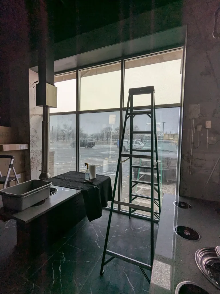 West-facing restaurant windows at K-Pot Korean BBQ in Sioux Falls after solar silver reflective film