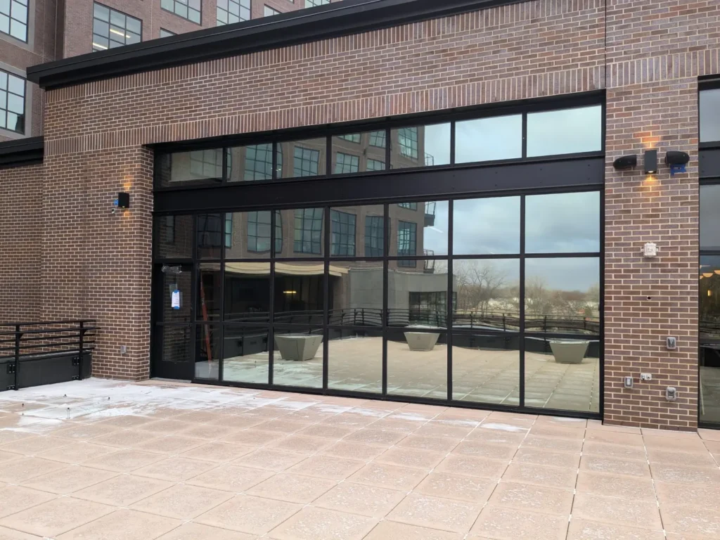 One-way mirror window film on a rooftop patio window wall at the Steel District in Sioux Falls
